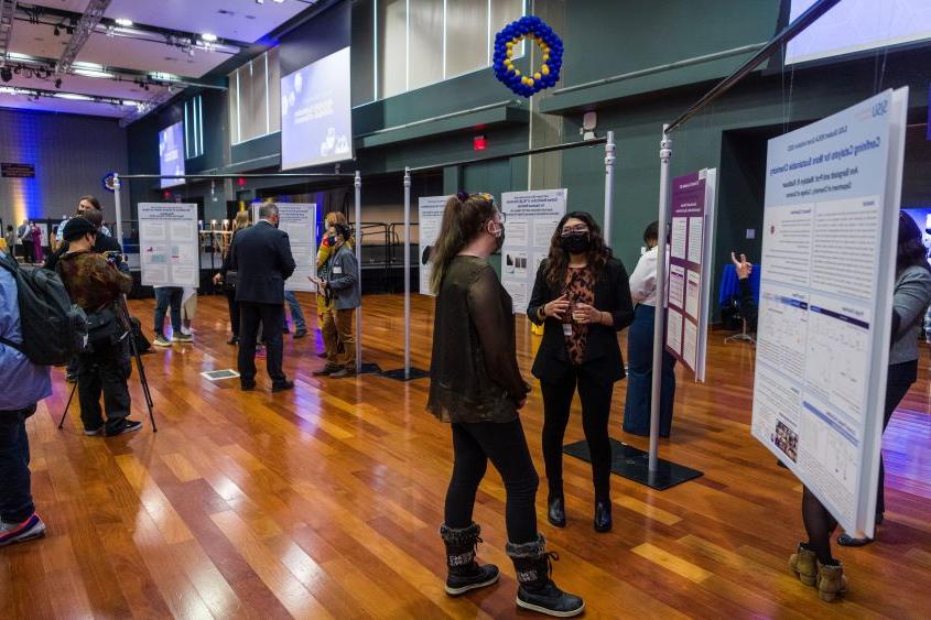 Students displaying their research posters. 